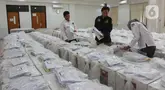 Aktivitas petugas Komisi Pemilihan Umum (KPU) DKI Jakarta saat mendistribusikan logistik pemilu di Kecamatan Makasar, Jakarta, Selasa (26/11/2024). (Liputan6.com/Herman Zakharia)
