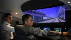 Seorang peserta pelatihan masinis untuk kereta cepat Jakarta-Bandung "Whoosh" dipandu oleh seorang instruktur asal China dalam simulator mengemudi di depo stasiun Tegalluar, Bandung, Jawa Barat, pada 17 Januari 2024. (Timur MATAHARI/AFP)