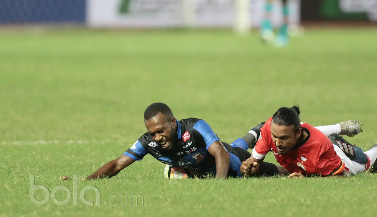 Pemain Madura United, Engelberd Sani (kiri) terjatuh saat berebut bola dengan pemain Persija Jakarta, Rohit Chan pada lanjutan Liga 1 2017 di Stadion Patriot, Bekasi, Kamis (4/5/2017). Persija kalah 0-1. (Bola.com/Nicklas Hanoatubun)
