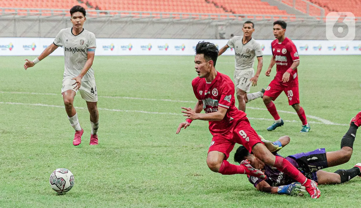 Gelandang Indonesia All Stars U-20, Brylian Aldama saat dilanggar kiper Bali United U-18, I Komang Aryantara pada pertandingan IYC 2021 di Jakarta International Stadium, Jakarta, Selasa (19/4/2022). Indonesia All Stars U-20 menang atas  Bali United U-18 2-1. (Liputan6.com/Faizal Fanani)