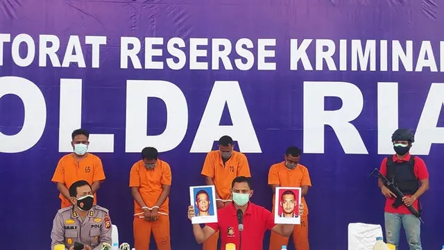 Direktur Reserse Kriminal Umum Polda Riau memperlihatkan foto dua buronan kasus bom molotov.