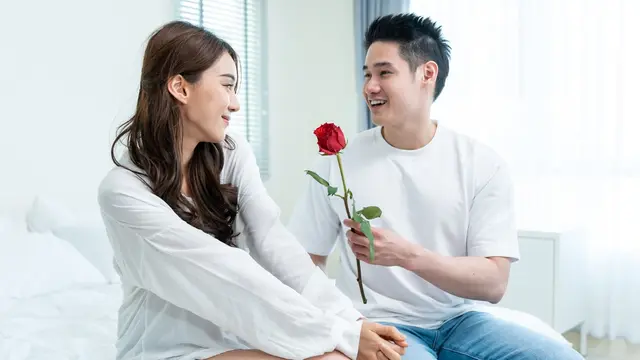 couple bahagia memberi bunga