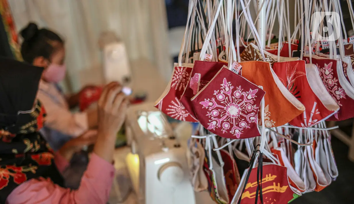 Perajin menyelesaikan pembuatan masker batik di Butik Elemwe, Jakarta, Jumat (2/10/2020). Spesifikasi masker kain ber-SNI terbagi menjadi tiga tipe antara lain tipe A untuk penggunaan umum, tipe B penggunaan filtrasi bakteri, dan tipe C penggunaan filtrasi partikel. (Liputan6.com/Faizal Fanani)