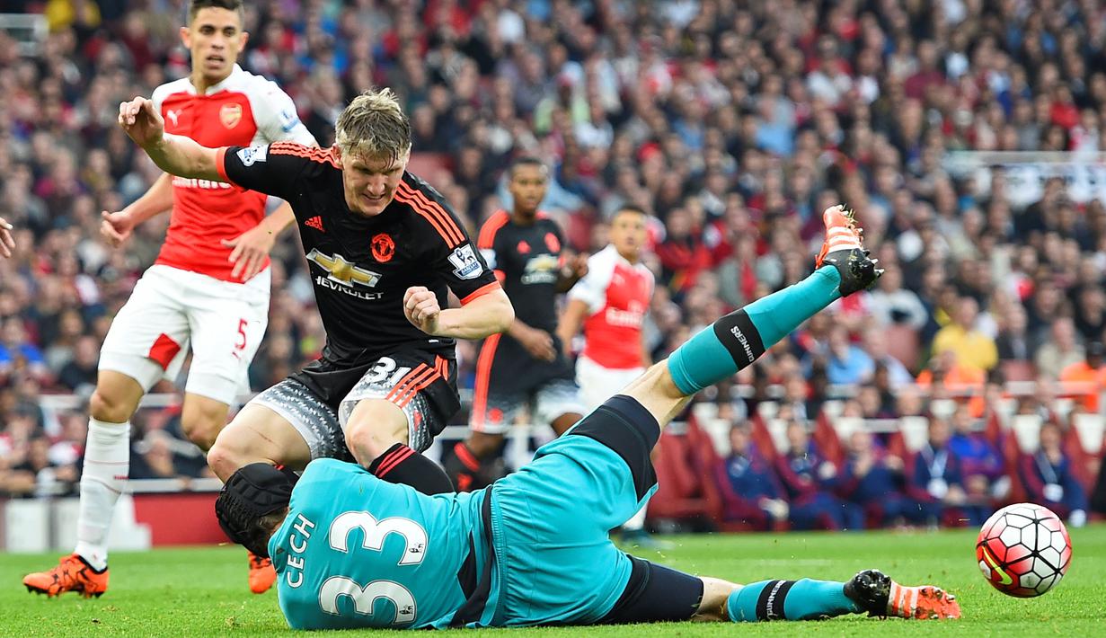 Pemain Manchester United Bastian Schweinsteiger berebut bola dengan Kiper Arsenal Petr Cech pada Laga lanjutan Liga Premier Inggris di Emirates Stadium. Minggu (04/10/2015). Arsenal menang 3-0. (Reuters / Dylan Martinez)