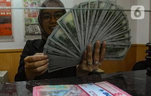 Petugas valas menghitung mata uang dolar AS di DolarAsia Valas di kawasan BSD, Tangerang Selatan, Banten, Selasa (16/4/2024). (merdeka.com/Arie Basuki)
