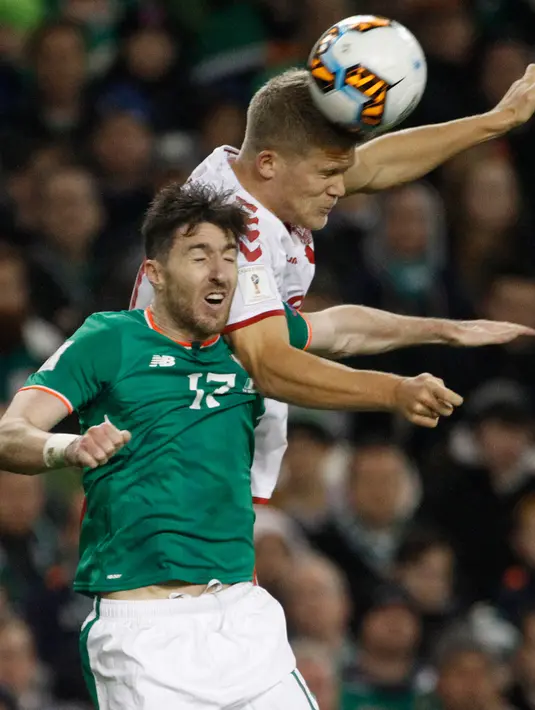 Pemain Republik Irlandia, Stephen Ward dan pemain Denmark, Peter Ankersen berebut bola pada partai kedua play-off zona Eropa di Stadion Aviva, Rabu (15/11). Denmark melaju ke putaran final Piala Dunia 2018 usai menang 5-1. (AP/Peter Morrison)