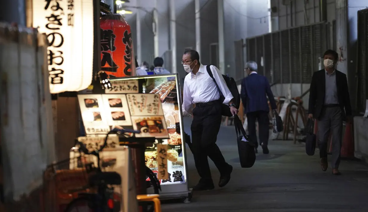 Orang-orang yang mengenakan masker pelindung untuk membantu mengekang penyebaran virus corona COVID-19 berjalan melewati jalan restoran di Tokyo, Jepang, Jumat (16/10/2020). Ibu Kota Jepang itu mengonfirmasi lebih dari 180 kasus virus corona COVID-19 baru pada hari Jumat. (AP Photo/Eugene Hoshiko)