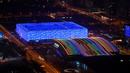 National Aquatics Center yang dikenal sebagai Ice Cube (kiri) venue untuk curling dan National Indoor Stadium (kanan) venue untuk hoki es pada Olimpiade Musim Dingin 2022 terlihat di Beijing, 3 Januari 2022. Olimpiade Musim Dingin 2022 akan dibuka pada 4 Februari mendatang. (GREG BAKER/AFP)