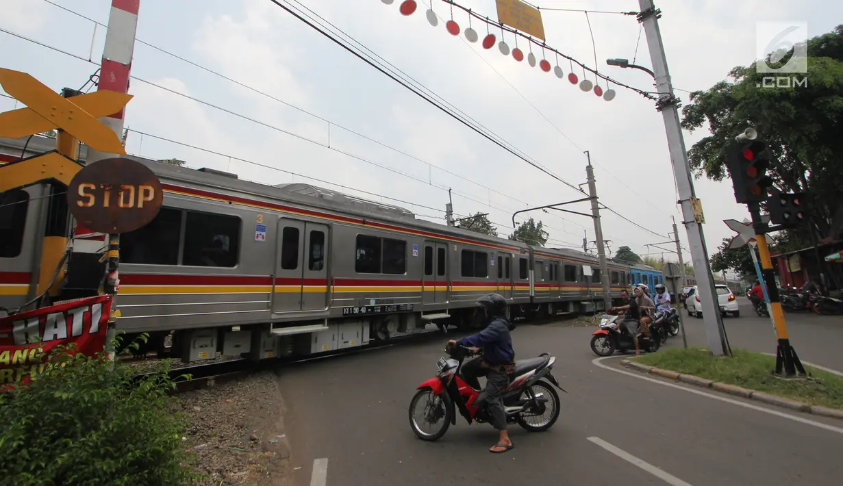 Sejumlah motor berhenti di pintu perlintasan kereta api Bintaro Permai yang tidak berfungsi di Jakarta, Kamis (25/10). Kondisi tersebut sangat membahayakan pengendara yang melintas. (Liputan6.com/Angga Yuniar)