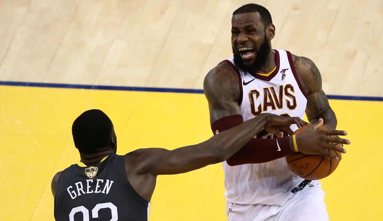 Pebasket Golden State Warriors, Draymond Green, berebut bola dengan pebasket Cleveland Cavaliers, LeBron James, pada final NBA di Oracle Arena, Oakland, Minggu (3/6/2018). Warriors menang 122-103 atas Cavaliers. (AFP/Ezra Shaw)