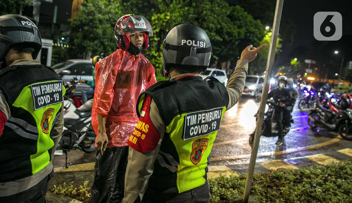 Polisi memberi arahan kepada pengendara motor saat penyekatan jalan di kawasan Pasar Baru, Jakarta, Kamis (31/12/2020). Polda Metro Jaya menutup sejumlah ruas jalan selama Car Free Night dan Crowd Free Night pada malam Tahun Baru 2021 untuk mencegah penyebaran COVID-19. (Liputan6.com/Faizal Fanani)