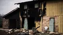 Sebuah rumah yang terbakar oleh kebakaran hutan di Saumos, pinggiran barat Bordeaux, barat daya Prancis (13/9/2022). Kebakaran yang berlangsung sejak 12 September 2022 telah menyebar sekitar 1800 hektar vegetasi dan hutan di Saumos dan memaksa evakuasi kota dalam konteks suhu tinggi di Gironde. (AFP/Philippe Lopez)