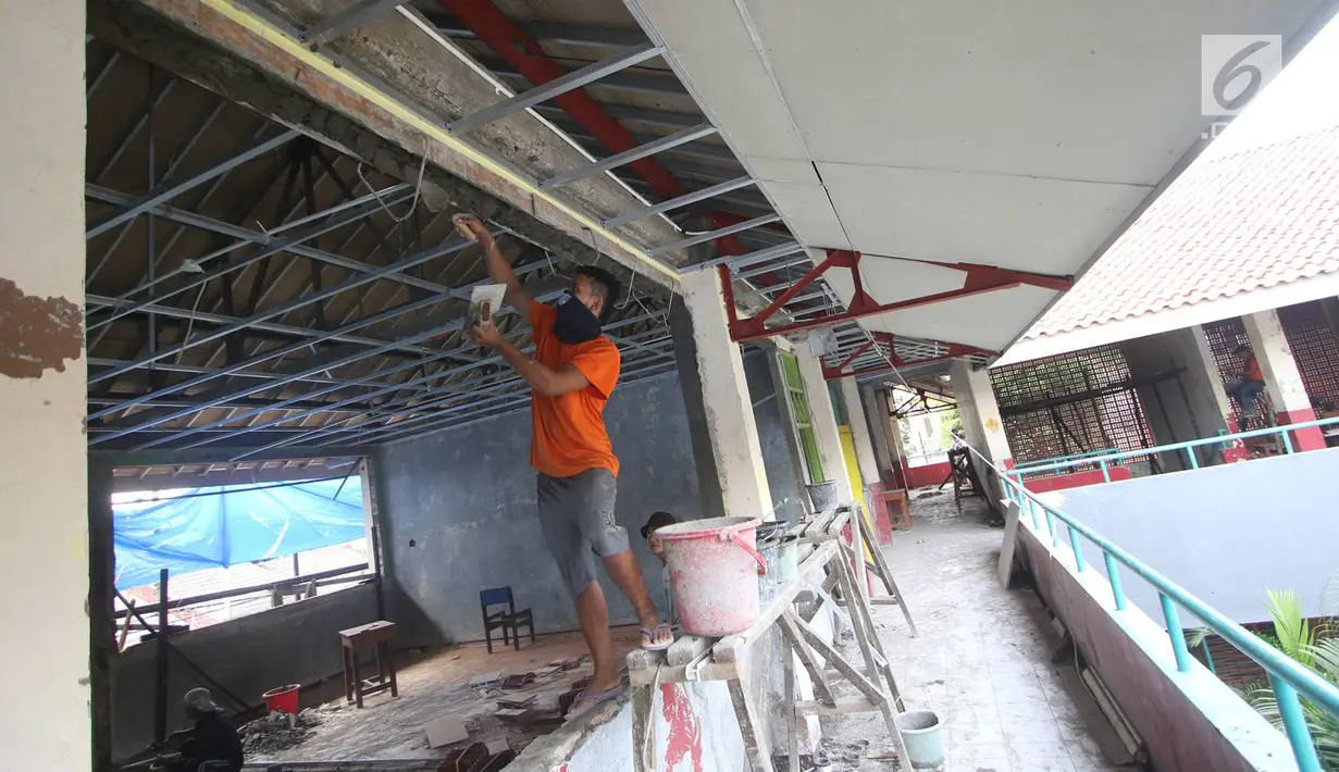 Pekerja menyelesaikan pengerjaan rehabilitasi SDN Cawang 04 di Jakarta, Kamis (23/11). Rehabilitasi berat 119 sekolah tersebut menggunakan APBD 2017 yang dianggarkan Suku Dinas Pendidikan masing-masing wilayah. (Liputan6.com/Immanuel Antonius)
