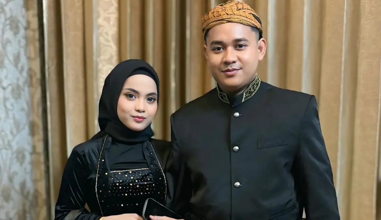 Putri Isnari membagikan potret terbarunya bareng suami ketika menghadiri prosesi siraman sekaligus mappaci calon suami Nia LIDA. Dalam momen bahagia tersebut, Putri tampil kompak dengan Abdul Azis mengenakan busana adat Jawa bernuansa hitam. (Liputan6.com/IG/@putriisnari3)