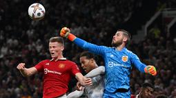Kiper MU, David de Gea (kanan), berhasil menghalau bola di udara dari pemain Liverpool, Virgil Van Dijk dalam pertandingan lanjutan Liga Inggris 2022/2023 yang berlangsung di Old Trafford, Senin (22/8/2022). (AFP/Paul Ellis)