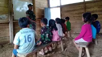 Seorang Babinsa tengah mengajar anak-anak di  Dusun Bombang, Desa Patambanua, Kecamatan Bulo, Kabupaten Polewali Mandar. 5 tahun desa ini tidak terjamah tenaga pendidik. (dok. TNI AD)