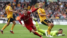 Bek Liverpool, Andy Robertson, menjebol gawang Wolverhampton Wanderers pada laga pekan kelima Premier League 2023/2024 yang berlangsung di Molineux Stadium, Sabtu (16/9/2023) malam WIB. (AFP/Adrian Dennis)