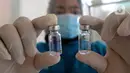 Dokter menunjukkan botol vaksin virus corona COVID-19 produksi Sinovac saat kegiatan vaksinasi di Puskemas Jagakarsa, Jakarta Selatan, Kamis (14/1/2020). Sejumlah Puskesmas di Jabodetabek mulai melakukan vaksinasi COVID-19 pada hari ini. (merdeka.com/Arie Basuki)