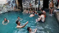 Wisatawan berendam di kolam air panas di ujung selatan Dataran Tinggi Golan yang dianeksasi Israel, dekat perbatasan dengan Yordania, 1 Maret 2019. Kolam dengan air panas itu berasal dari aliran pipa pengeboran di Lembah Hula. (MENAHEM KAHANA/AFP)
