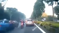 Ulah seorang sopir taksi yang tiba-tiba membuka pintu mobil di tengah jalan membuat pengendara motor mengalami kecelakaan.