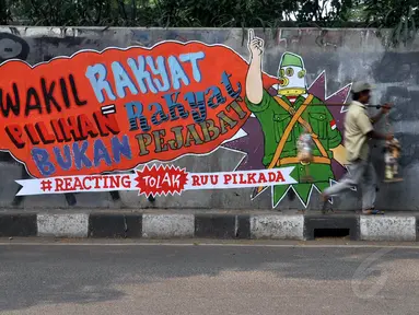 Sebuah mural terpampang di tembok fly over kawasan Pejompongan, Jakarta, (28/9/14). (Liputan6.com/Miftahul Hayat) 