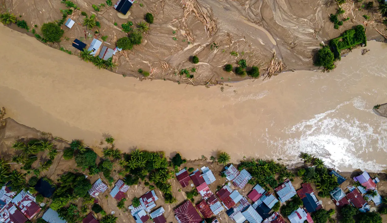 Permukiman warga nyaris tenggelam tidak terlihat lagi akibat terendam banjir. Tampak foto udara menunjukkan rumah-rumah warga yang rusak akibat banjir bandang di Meureudu, Kabupaten Pidie Jaya, provinsi Aceh, pada Jumat 28 November 2025. (CHAIDEER MAHYUDDIN/AFP)