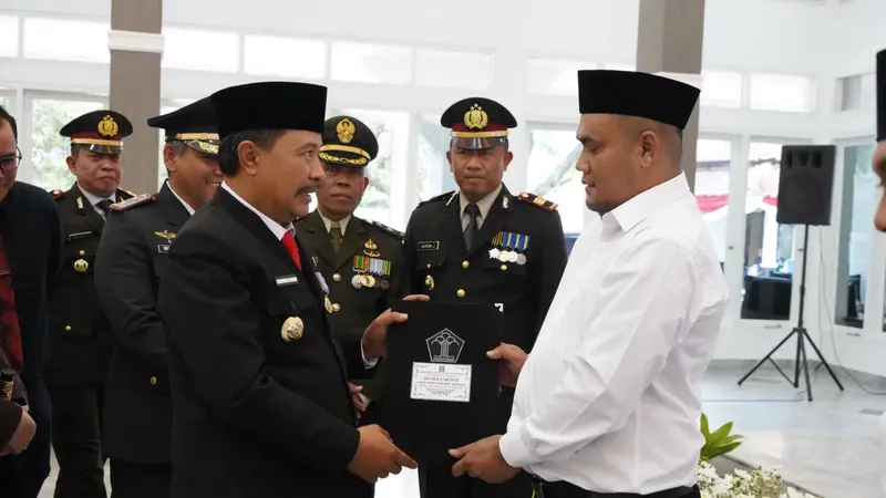 Pj. Bupati Barnas Adjidin memberikan simbolis pemberian SK Remisi kepada narapidana lapas Garut pada puncak perayaan HUT ke-79 RI di Gedung Pendopo Garut. (Liputan6.com/Jayadi Supriadin)