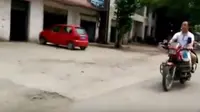 Pria buta  tertangkap kamera mengendarai sepeda motor sambil membonceng istrinya.