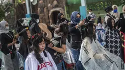 Penata rambut memberikan potongan rambut gratis sebagai bagian dari amal Muslim untuk yang membutuhkan saat umat Islam di seluruh dunia merayakan bulan suci Ramadhan di Muhammad Cheng Hoo di Surabaya (18/4/2022). (AFP/Juni Kriswanto)