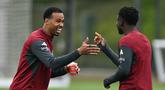 Pemain Arsenal, Gabriel Magalhaes (kiri) tampak sedang bercanda dengan rekan satu timnya pada sesi latihan jelang leg kedua semifinal Liga Champions melawan Atletico Madrid di Emirates Stadium, London, Rabu (6/5/2026) dini hari WIB. (AFP/Glyn Kirk)