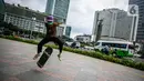 Aksi warga saat bermain skateboard di trotoar Jalan Sudirman-Thamrin, Jakarta, Jumat (5/3/2021). Gubernur DKI Jakarta Anies Baswedan mengizinkan trotoar untuk digunakan sebagai tempat bermain skateboard dengan beberapa kesepakatan. (Liputan6.com/Faizal Fanani)