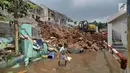 Seorang anak berjalan di dekat turap yang ambrol Kali Jantung, kawasan Perumahan Cluster Azzura, Sukamaju, Depok, Jawa Barat, Kamis (21/2). Turap tersebut memiliki  tinggi 20 meter dan panjangnya 100 meter. (Liputan6.com/Herman Zakharia)