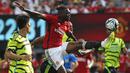 Bek Manchester United, Aaaron Wan-Bissaka mengontrol bola di antara dua pemain Arsenal, Takehiro Tomiyasu dan Gabriel Magalhaes pada laga pramusim 2023/2024 di MetLife Stadium, New Jersey, USA, Minggu (23/7/2023) pagi WIB. (AFP/Leonardo Munoz)
