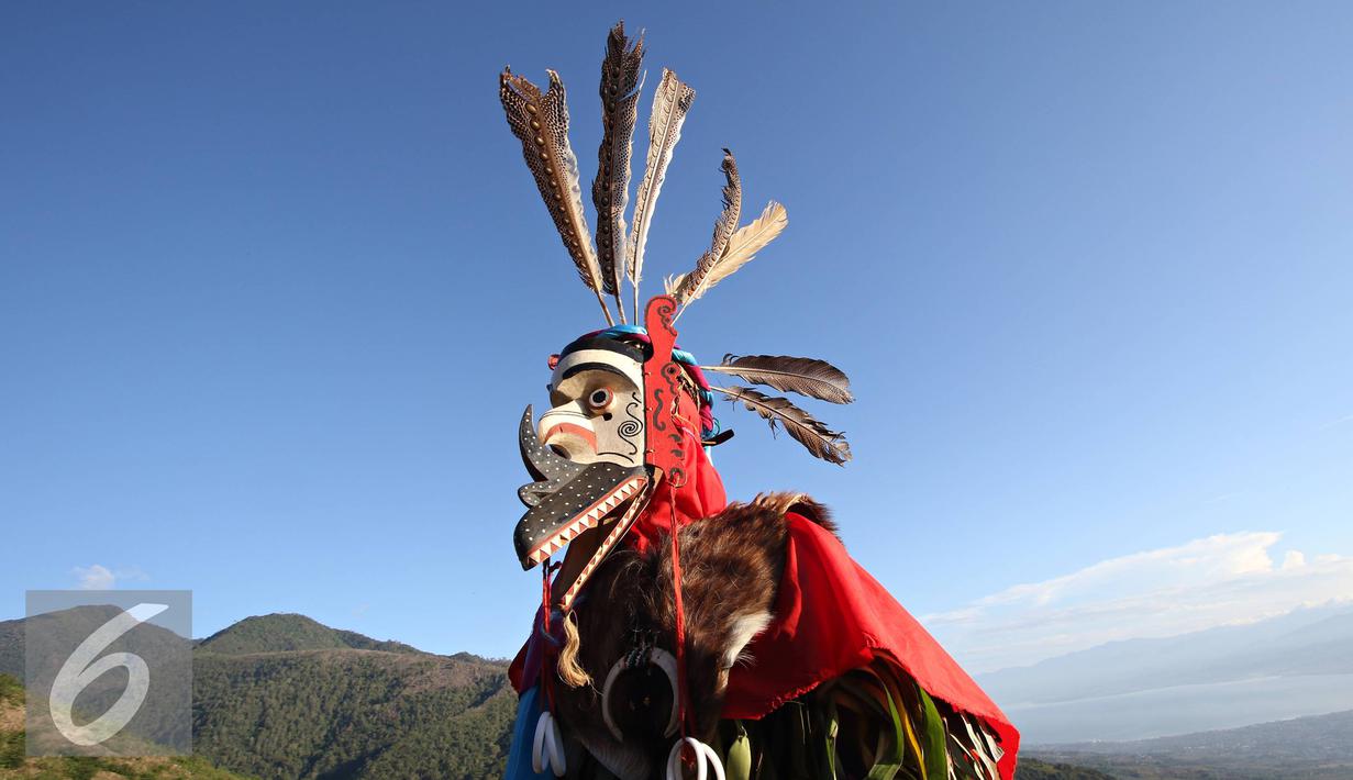 Seniman mementaskan tarian khas Toraja dan Dayak di Bukit Matantimali, Sigi, Sulawesi Tengah, Rabu (9/3). Tarian tersebut dilakukan dalam rangka menyambut gerhana matahari total serta menolak bala. (Liputan6.com/Immanuel Antonius)