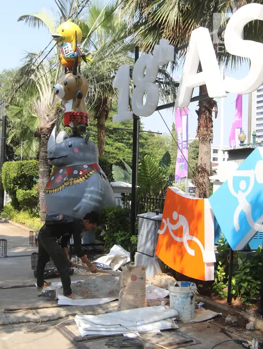 Pekerja memasang neon box Asian Games di depan Balai Kota DKI Jakarta, Jumat (6/7). Pemasangan neon box tersebut untuk mensosialisasikan pelaksanaan Asian Games 2018. (Liputan6.com/Arya Manggala)
