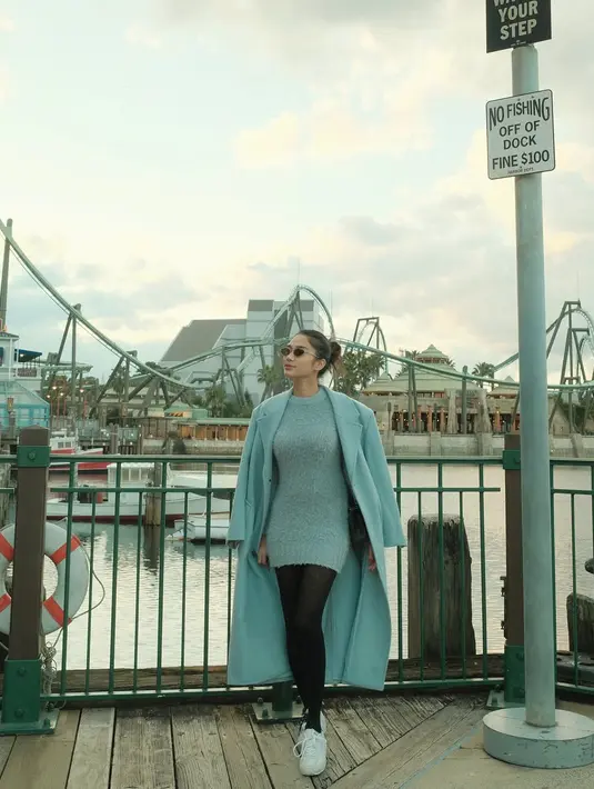 Liburan di Jepang, Azizah Salsha padukan kniteed mini dress dan wool long coat sky blue. Tampilan cerahnya dipadu dengan stocking hitam [@azizahsalsha_]
