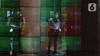 Aktivitas pekerja di depan layar Indeks Harga Saham Gabungan (IHSG) di BEI, Jakarta, Senin (3/1/2022). Pada pembukan perdagagangan bursa saham 2022 Indeks Harga Saham Gabungan (IHSG) langsung menguat 7,0 poin atau 0,11% di level Rp6.588,57. (Liputan6.com/Angga Yuniar)
