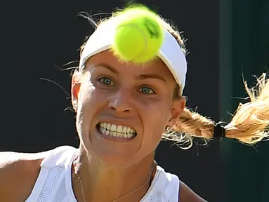 Petenis Jerman, Angelique Kerber mengembalikan bola ke arah petenis AS, Lauren Davis pada babak kedua Wimbledon di All England Lawn Tennis Club, Kamis (4/7/2019). Langkah juara bertahan Wimbledon, Angelique Kerber, terhenti setelah kalah dari petenis non-unggulan  2-6, 6-2, 6-1. (Ben STANSALL/AFP)