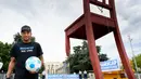 Penyerang PSG, Neymar Jr berpose disamping kursi raksasa 'Broken Chair' selama acara yang diselenggarakan oleh LSM Handicap International di Place des Nations, Jenewa, Swiss (15/7). (Laurent Gillieron/Keystone via AP)