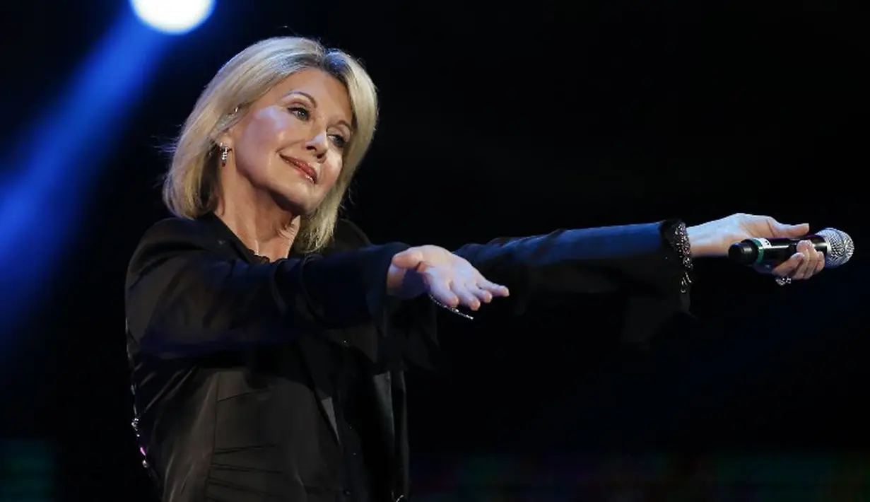Olivia Newton-John didiagnosa kanker pada tahun 2004. Ia pun harus melakukan serangkaian perawatan untuk berjuang melawan sakitnya. (PAUL PLAZA / AFP)