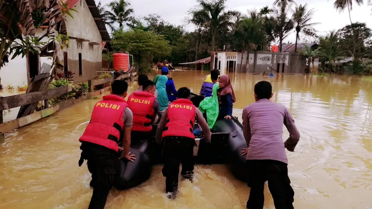 Warga yang berada di lokasi terisolir karena banjir, diantar dengan perahu karet menuju TPS.