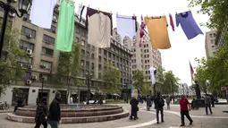 Seni instalasi seperti jemuran pakaian raksasa menjadi perhatian para pengunjung di Paseo Bulnes, Santiago (2/10). Instalasi yang mirip jemuran ini dipajang 50 meter melintang di kawasan Paseo Bulnes. (AFP Photo/Martin Bernetti)