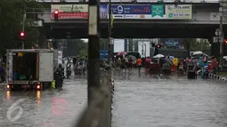 Hujan yang turun sejak dini hari menyebabkan Jalan Gunung Sahari, Jakarta Pusat, terendam banjir, Selasa (21/2). Banjir setinggi pinggang orang dewasa menyebabkan terputusnya sejumlah akses jalan untuk kendaraan bermotor. (Liputan6.com/Faizal Fanani)