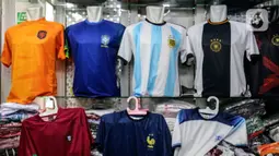 Jersey timnas sepak bola peserta Piala Dunia Qatar 2022 dipajang di salah satu kios Blok B Pasar Tanah Abang, Jakarta, Kamis (24/11/2022). Menurut pedagang, permintaan jersey timnas meningkat dikarenakan Piala Dunia Qatar 2022 yang dimulai sejak 20 November 2022. (Liputan6.com/Johan Tallo)