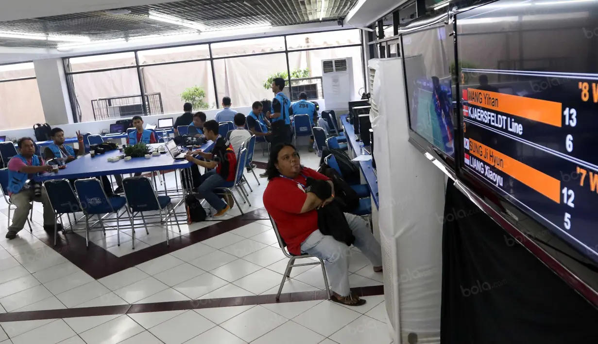 Seorang Jurnalis tengah mengamati skor saat meliput turnamen Indonesia Open 2016 di Istora Senayan, Jakarta. (Bola.com/Nicklas Hanoatubun)