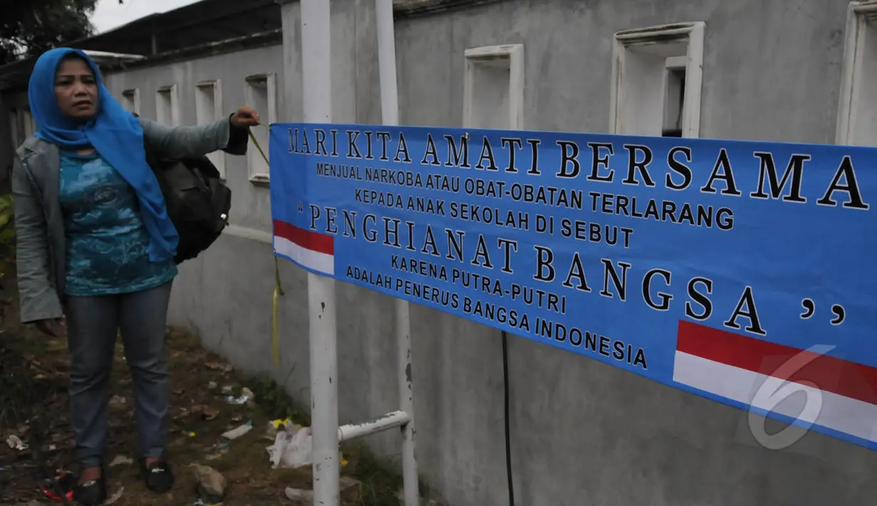 Ecin menggelar aksi protes seorang diri di depan dermaga Wijaya Pura, Cilacap, Jawa Tengah, Minggu (8/3/2015). Ecin mengharapkan agar pemerintah mempercepat eksekusi mati terpidana narkoba. (Liputan6.com/Johan Tallo)