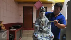 Seorang umat membersihkan patung dewa-dewi saat ritual cuci dewa di Klenteng Dharma Bhakti,Jakarta, minggu, (31/1). Pencucian sejumlah patung ini dilakukan guna menyambut tahun baru imlek China 2567. (Liputan6.com/Gempur M Surya)