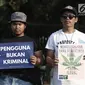 Aktivis menggelar aksi Renungan 10 Tahun Undang-Undang Narkotika di Taman Aspirasi, Monas, Jakarta, Selasa (25/6/2019). Aksi yang dihadiri oleh keluarga korban UU Narkotika tersebut menuntut pemerintah segera merevisi Undang-Undang No.35 Tahun 2009 tentang Narkotika. (merdeka.com/Iqbal S Nugroho)