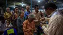 Penggunaan unsur budaya Jawa dalam perayaan keagamaan menjadi ciri khas Gereja Hati Kudus Tuhan Yesus (HKTY) Ganjuran, Bantul, Yogyakarta. Tampak dalam foto, para umat Katolik yang mengenakan pakaian tradisional Jawa menerima Komuni Kudus dari seorang imam selama Misa Malam Natal di Gereja Hati Kudus Yesus di Ganjuran, Bantul, Yogyakarta, pada Rabu 24 Desember 2025. (DEVI RAHMAN/AFP)