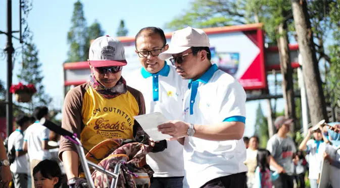 General Manager PLN Distribusi Jawa Barat Iwan Purwana (kanan) menjelaskan aplikasi PLN Mobile kepada peserta Car Free Day dalam rangka Hari Pelanggan Nasional di Bandung (10/9/2017)